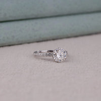Diamond ring on a light gray surface with a neutral background