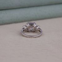 Silver ring with a central gemstone on a neutral background