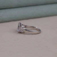 Silver ring with a large diamond on a neutral background