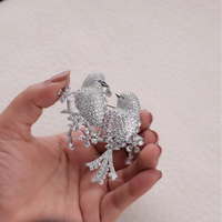 Silver bird-shaped brooch held in a hand against a neutral background, Round & Marquise CZ Stone Bird Brooch – Colorful Love Bird Jewelry Gift