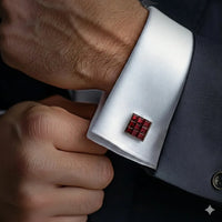 Close-up of a cufflink on a suit cuff with a dark background