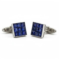 Pair of blue square cufflinks with silver border on a white background