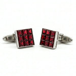 Red square cufflinks with silver border on a white background