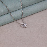 Silver necklace with a delicate pendant on a textured surface, Nature Inspired Butterfly Necklace – Marquise & Round Moissanite Pendant Jewelry Gift