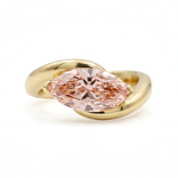Gold ring with a pink gemstone on a white background