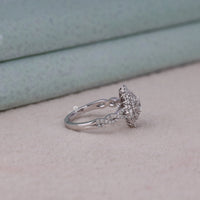 Silver ring with diamond details on a light background, Vintage Inspired Oval Starburst Halo Engagement Ring with Tapered Baguette CZ Stones