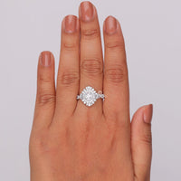 Diamond ring on a hand with a plain background, Oval & Tapered Baguette CZ Halo Engagement Ring, Starburst Vintage Wedding Ring
