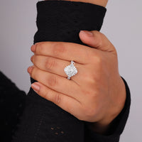 Hand wearing a diamond ring with a blurred background, Vintage Oval Starburst Halo Ring with Tapered Baguette CZ, Elegant Engagement Jewelry