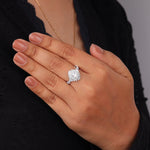 Hand wearing a diamond ring with a blurred background, Oval & Tapered Baguette CZ Starburst Halo Engagement Ring, Vintage Inspired Wedding Jewelry