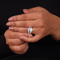 Hand wearing a diamond ring on a black background, Moissanite Engagement Ring and Curved Wedding Band Set, Vintage Inspired Bridal Jewelry