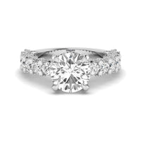 Diamond ring with a central gemstone and smaller diamonds on a white background