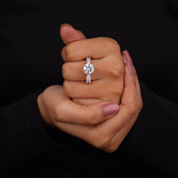 Diamond ring on a hand against a black background