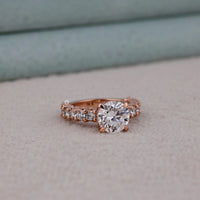 Rose gold diamond ring on a neutral background