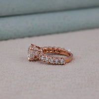 Rose gold ring with diamonds on a light gray surface