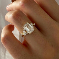 Close-up of a hand wearing a diamond ring with a white background