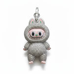 Pig-shaped charm with rhinestone detailing on a white background