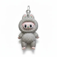 Pig-shaped charm with rhinestone detailing on a white background