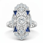 Elegant ring with blue gemstones and diamond accents on a white background