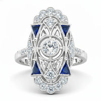 Elegant ring with blue gemstones and diamond accents on a white background