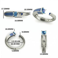 Silver ring with blue gemstones and measurements on a white background