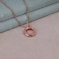 Rose gold necklace with a circular pendant on a textured surface, Rose Gold Linked Circle Pendant Necklace, Minimalist Everyday Jewelry