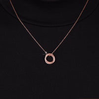 Rose gold necklace with a circular pendant on a black background, Triple Interlocking Circle Necklace, Rose Gold Pendant with Moissanite  Accents