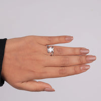 Hand wearing a diamond ring on a plain background, Clean Line Engagement Ring, Geometric Moissanite Ring, White Gold Moissanite Bypass Ring, Bold Engagement Ring