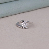Silver ring with a diamond on a light gray surface, Moissanite Bridal Jewelry, Princess Cut Bypass Shank Ring, Elegant Moissanite Solitaire, Modern Wedding Ring