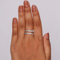 Hand wearing a silver ring on a plain background, Stackable Round Moissanite Wedding Band – Diamond Enhancer Guard Ring