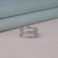 Silver ring with diamond accents on a light surface, Round Brilliant Moissanite Wedding Band – Enhancer & Guard Style Diamond Ring