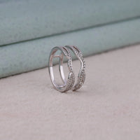 Silver ring with diamond accents on a light gray surface, Stackable Diamond Guard Band – Round Moissanite Enhancer Wedding Ring for Women