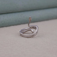 Silver snake-shaped ring on a neutral background
