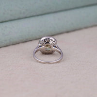 Silver ring with intricate design on a light background, Old Mine Cut CZ Sapphire Halo Ring – Vintage Art Deco Heirloom Inspired Jewelry