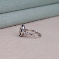 Silver ring with a blue and yellow gemstone on a light background, Art Deco Antique Sapphire Halo Ring – Vintage Old Mine Cut CZ Stone Jewelry