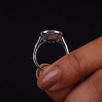 Silver ring held between fingers against a black background, Art Deco Vintage Ring – Antique Old Mine Cut CZ with Sapphire Halo Design