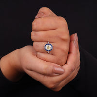 Hand holding a ring with a blue gemstone against a black background, Old Mine Cut CZ Stone Vintage Ring – Sapphire Halo Art Deco Statement Jewelry