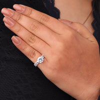 Hand wearing a diamond ring on a black background, Round Moissanite Solitaire Engagement Ring Set with Matching Eternity Wedding Band