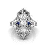 Elegant diamond ring with blue accents on a white background
