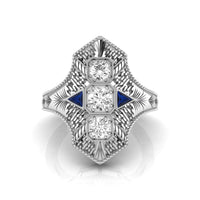 Elegant diamond ring with blue accents on a white background