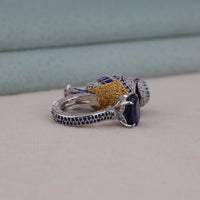 Close-up of a silver ring with gemstones on a neutral background