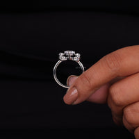 Silver ring with a diamond on a black background