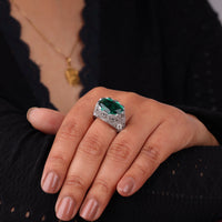 Hand wearing a ring with a green gemstone against a neutral background, Vintage Emerald Green CZ Ring with Filigree Detailing, Antique Style Women’s Cocktail Ring