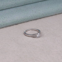 Silver ring with a diamond on a light gray surface, silver vintage ring
unique moissanite ring