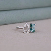 Two diamond earrings on a neutral background, Two Stone Bridal Jewelry With Toi Et Moi Design, Chic Pear And Radiant Moissanite Anniversary Ring, Sustainable Conflict Free Moissanite Engagement Jewelry