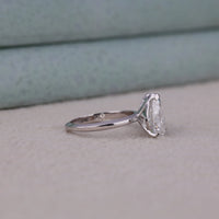 Silver ring with a large diamond on a light gray surface, Two Stone White Pear & Green Radiant Moissanite Engagement Ring – Toi Et Moi Style