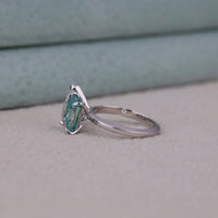 Silver ring with a green gemstone on a neutral background, Pear And Radiant Cut Moissanite Bridal Jewelry, Romantic Toi Et Moi Moissanite Wedding Ring, Elegant Green And White Moissanite Proposal Ring
