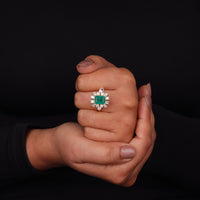 Hand holding a ring with an emerald and diamond design against a black background, Green Emerald Cut Cubic Zirconia Engagement Ring – 14K Gold Wedding Jewelry
