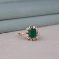 Gold ring with a green gemstone and diamond accents on a textured surface, Green Emerald Cut CZ Stone Engagement Ring – 14K Yellow Gold Wedding Ring, Classic Solitaire Emerald Cut Green CZ Bridal Jewelry
