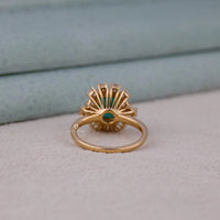 Gold ring with a green gemstone on a light gray surface, Vintage Style 14K Yellow Gold Green Emerald Cut CZ Ring – Engagement & Bridal Jewelry