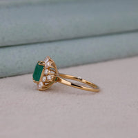 Gold ring with a green gemstone and small diamonds on a light background, Green Emerald Cut Cubic Zirconia Ring – 14K Yellow Gold Wedding & Engagement Jewelry